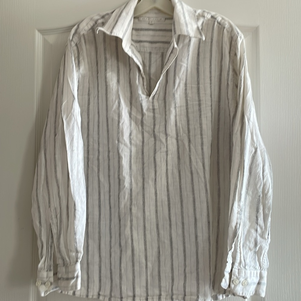 50% linen 50% cotton v neck shirt w long sleeves. Can be dress or casual.